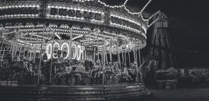 A black and white carousel at night