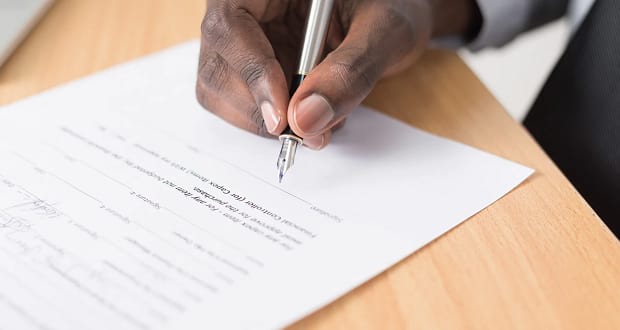 Someone signing a legal document.